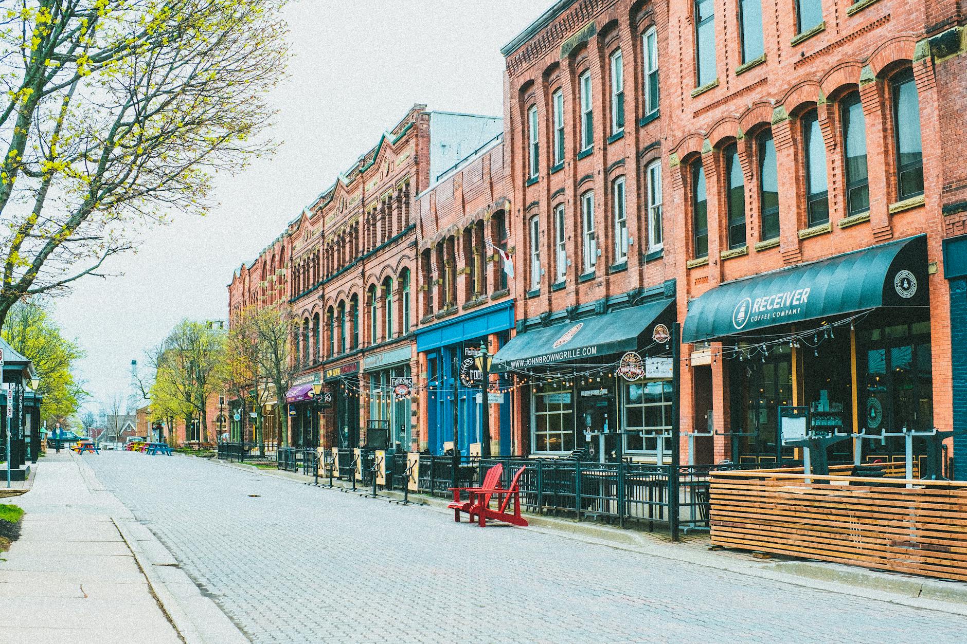 A street of historic brick buildings with outdoor cafes