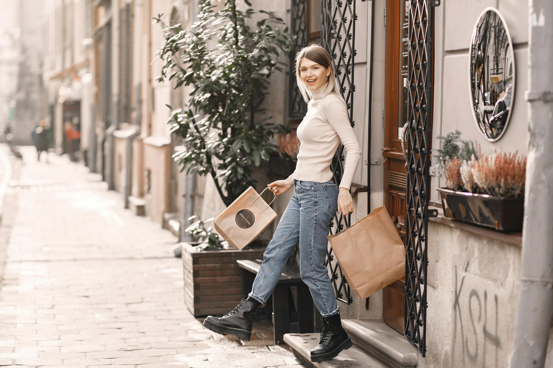 A person walking with shopping bags on a lively city street