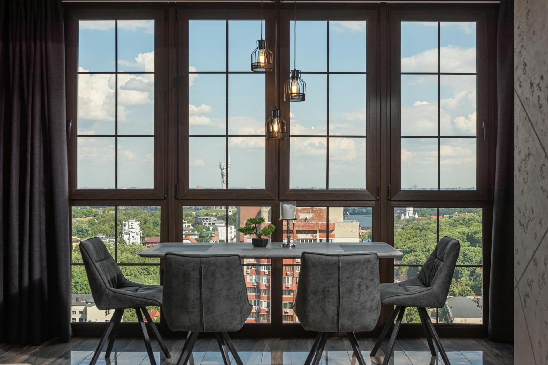 A stylish dining room with large windows overlooking a city skyline