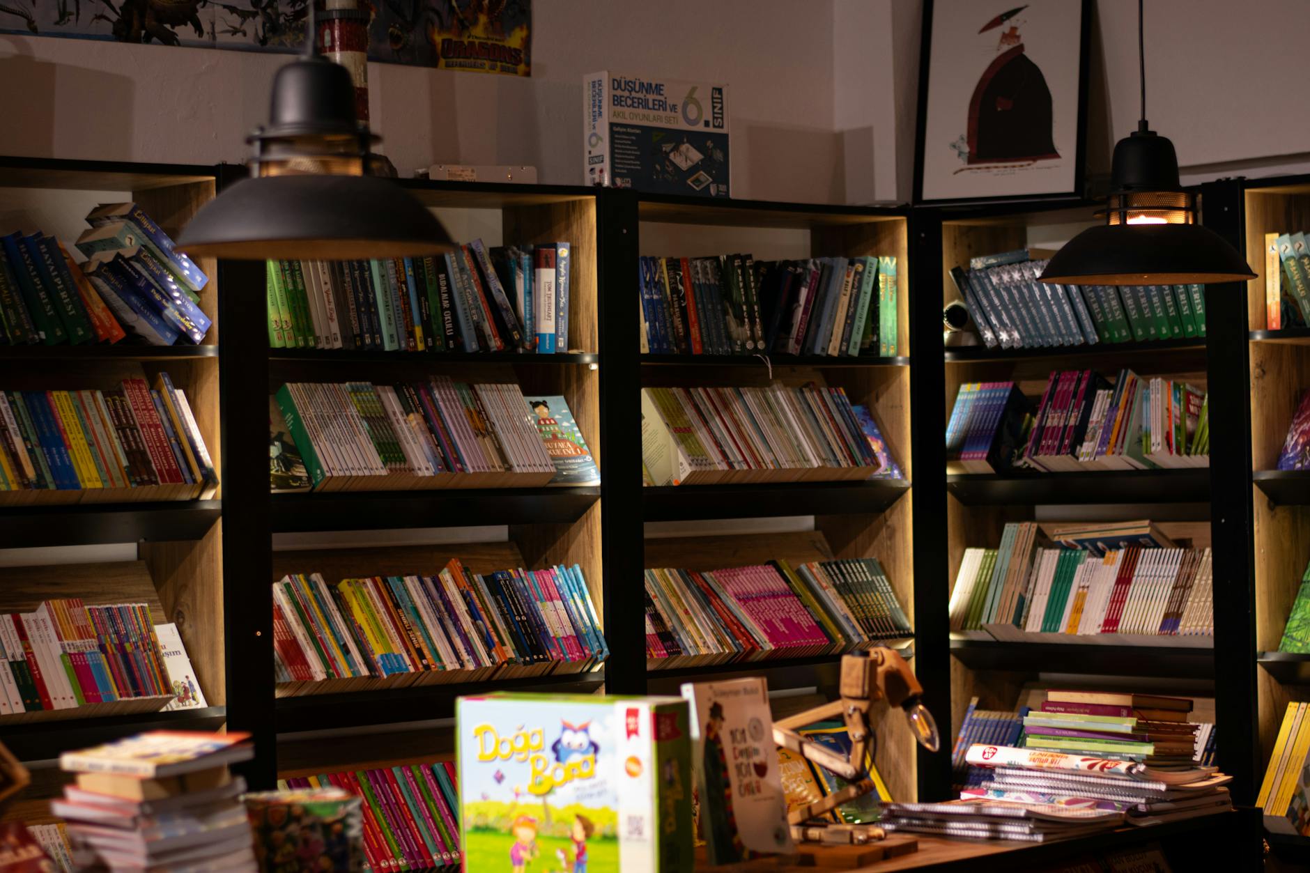 Warmly lit shelves inside a cozy bookstore