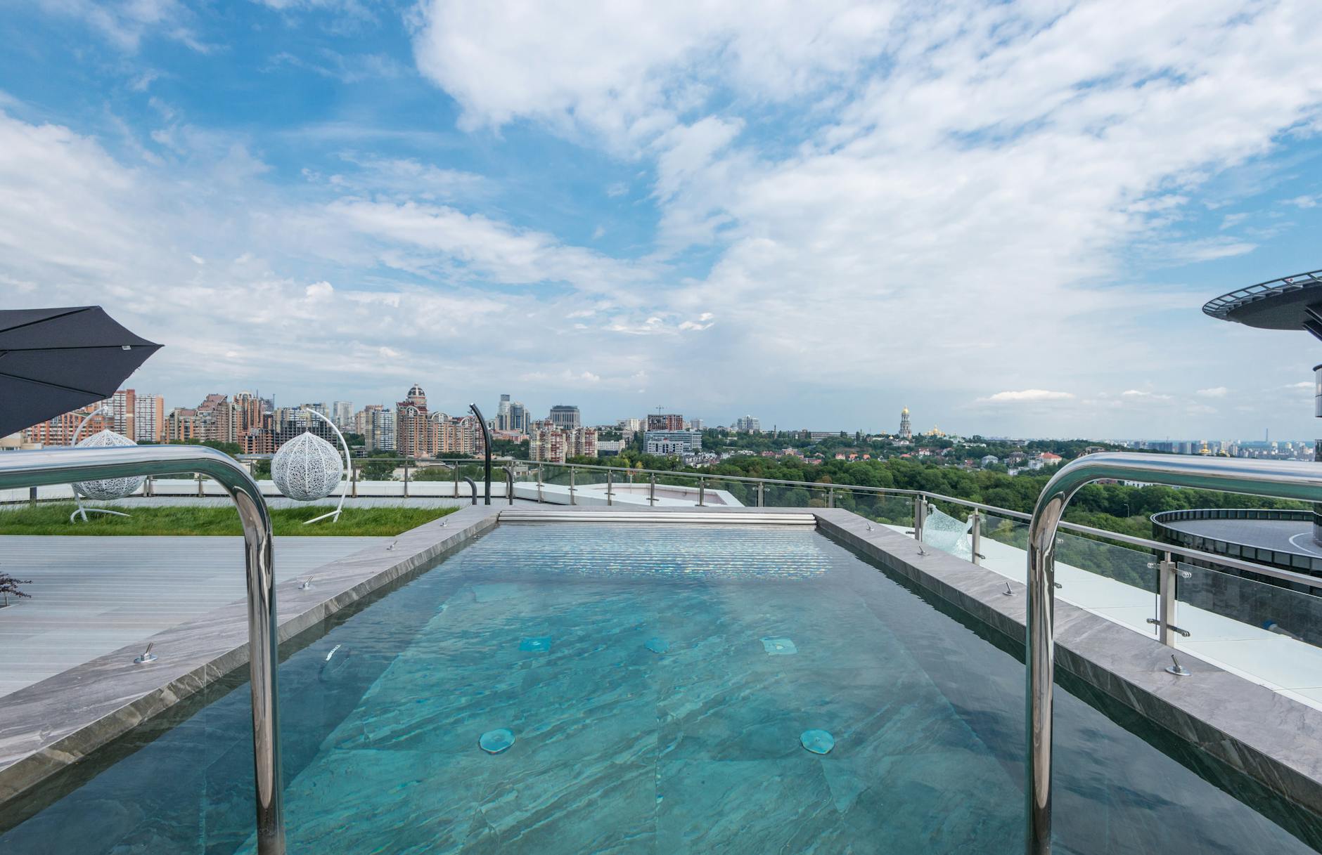 A luxurious rooftop pool with a city skyline backdrop