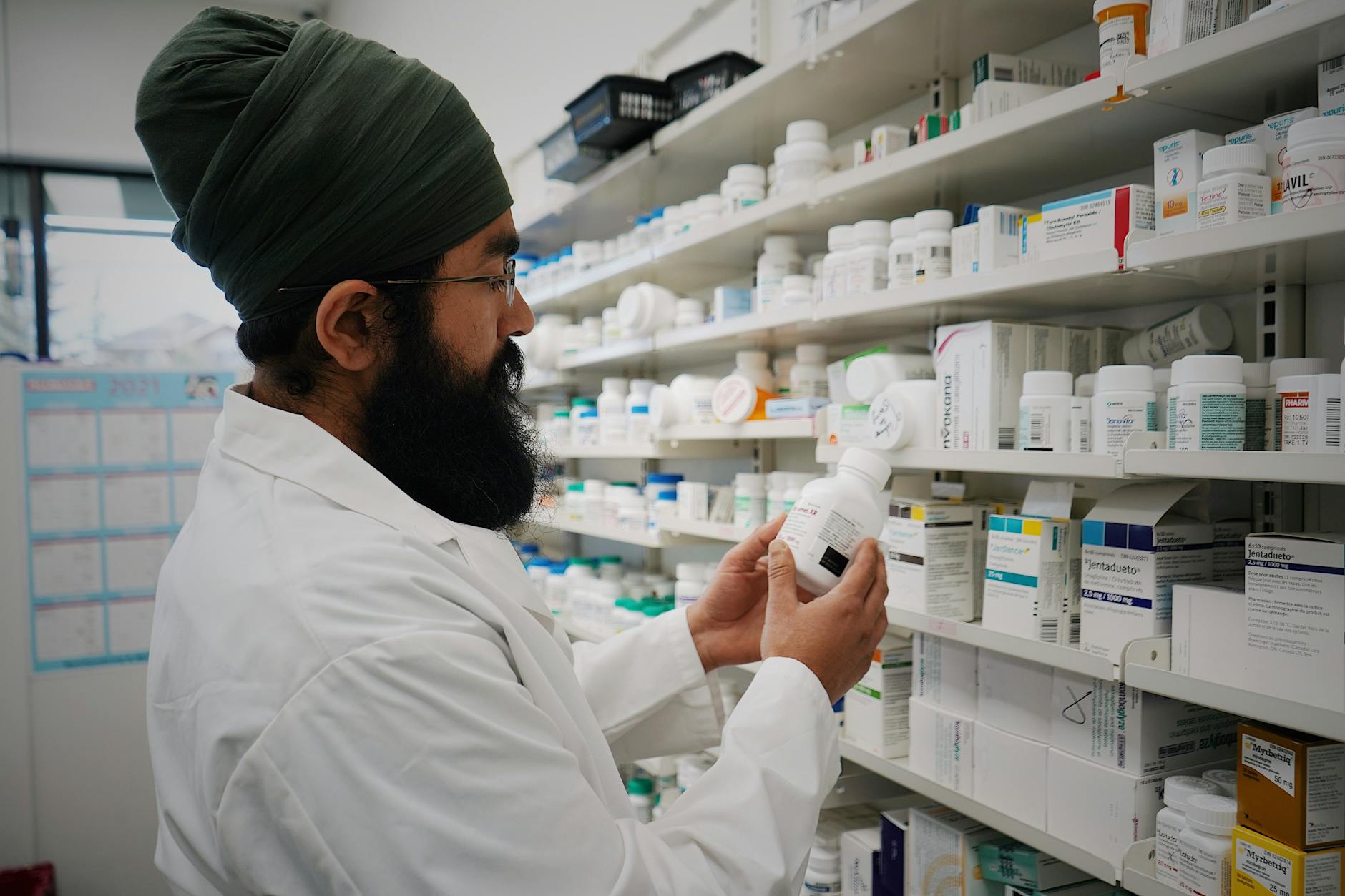 A pharmacist organizing shelves in a pharmacy