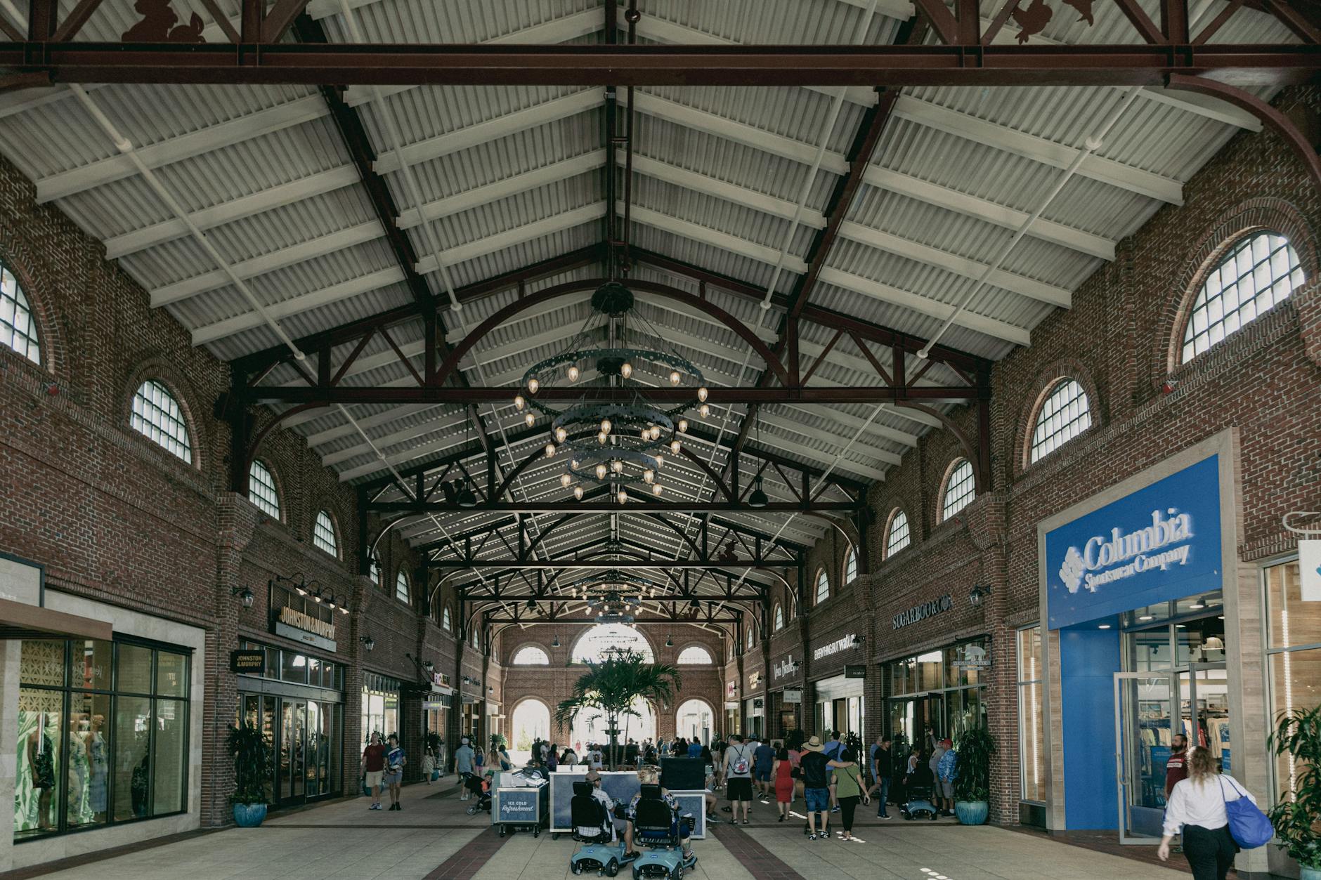 An upscale shopping concourse with stores and shoppers