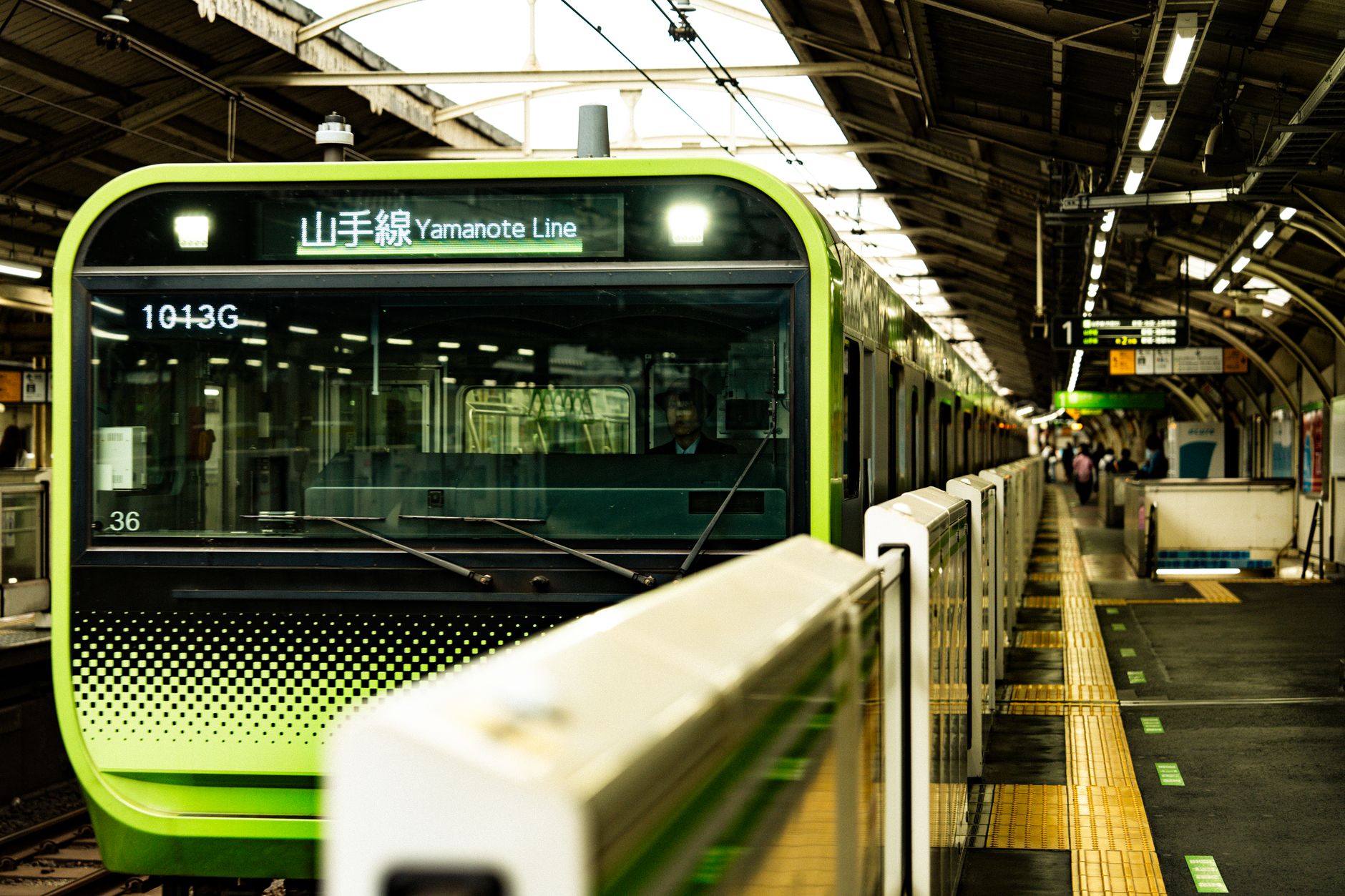 A train arriving at a busy station platform