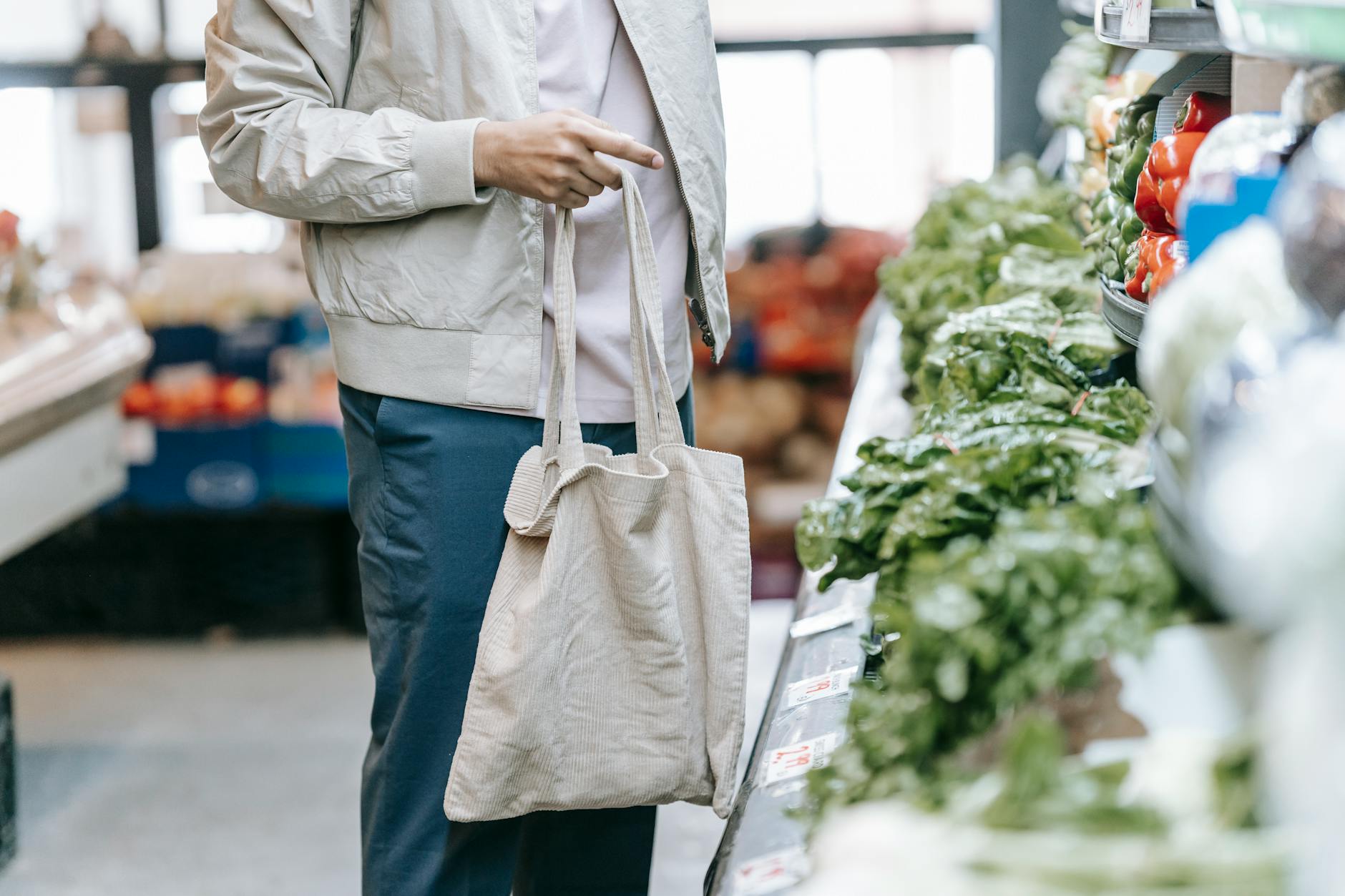 A shopper choosing fresh produce at a supermarket