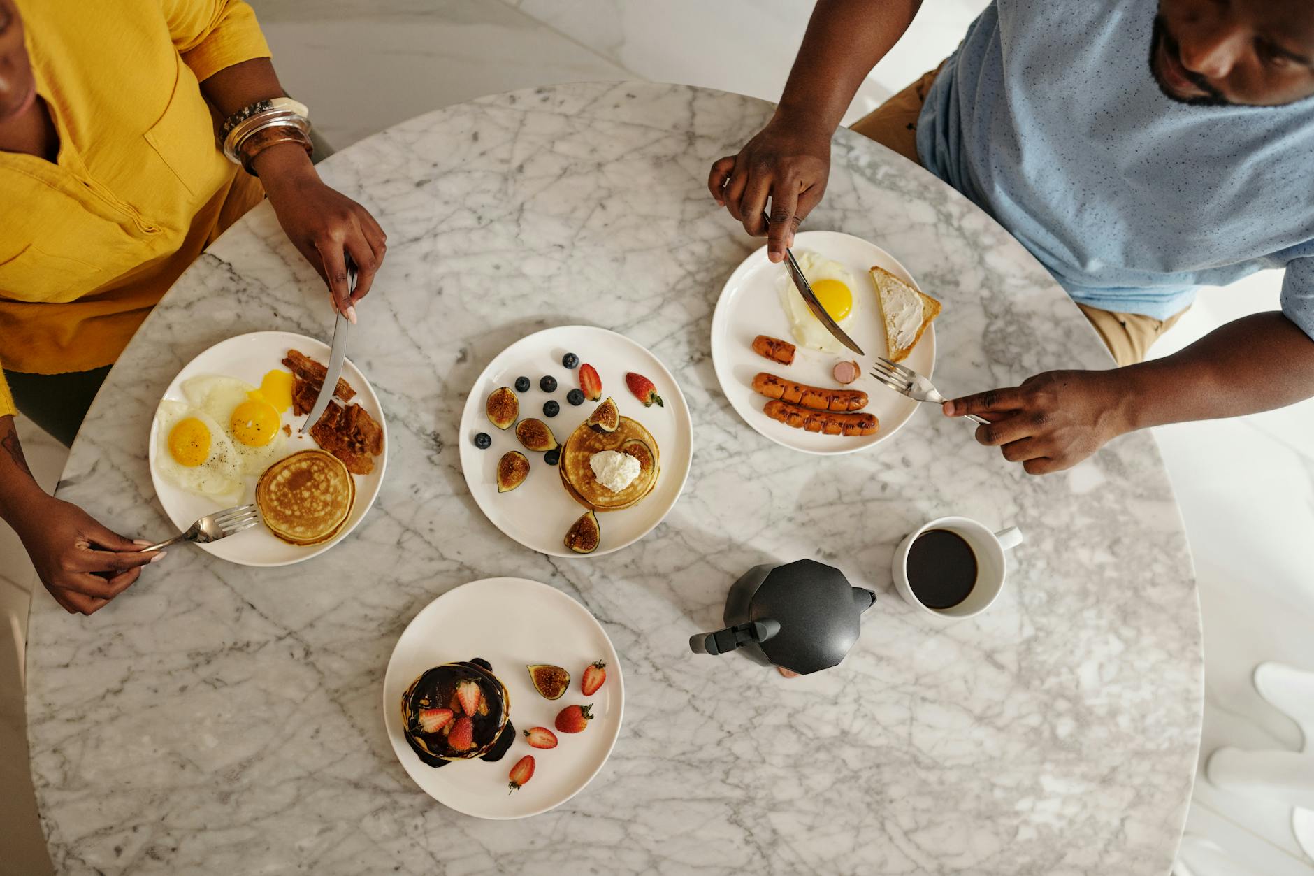 Overhead shot of a brunch table with pancakes and coffee