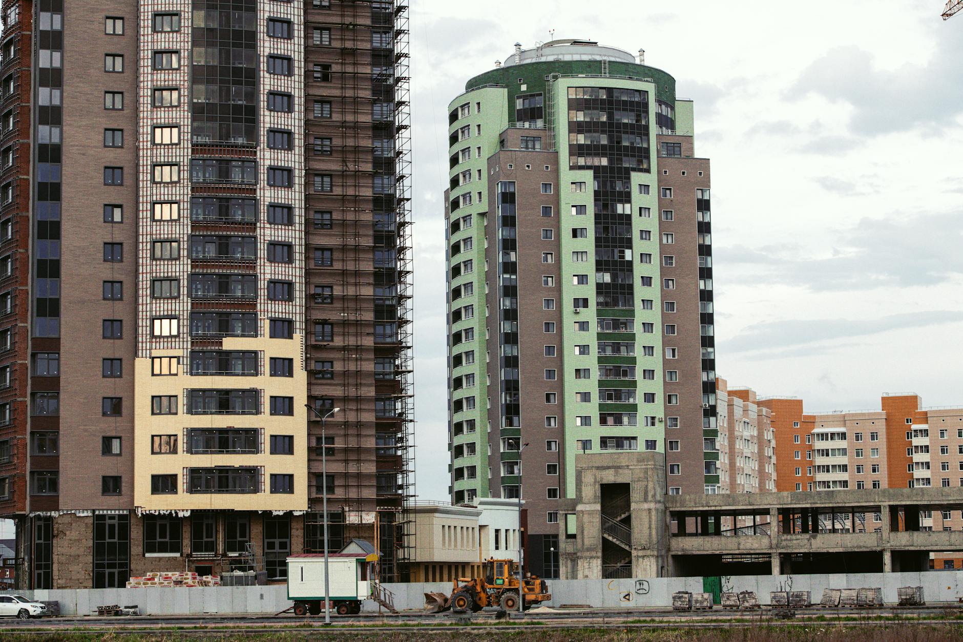 A city skyline with contemporary high-rise buildings and a construction site