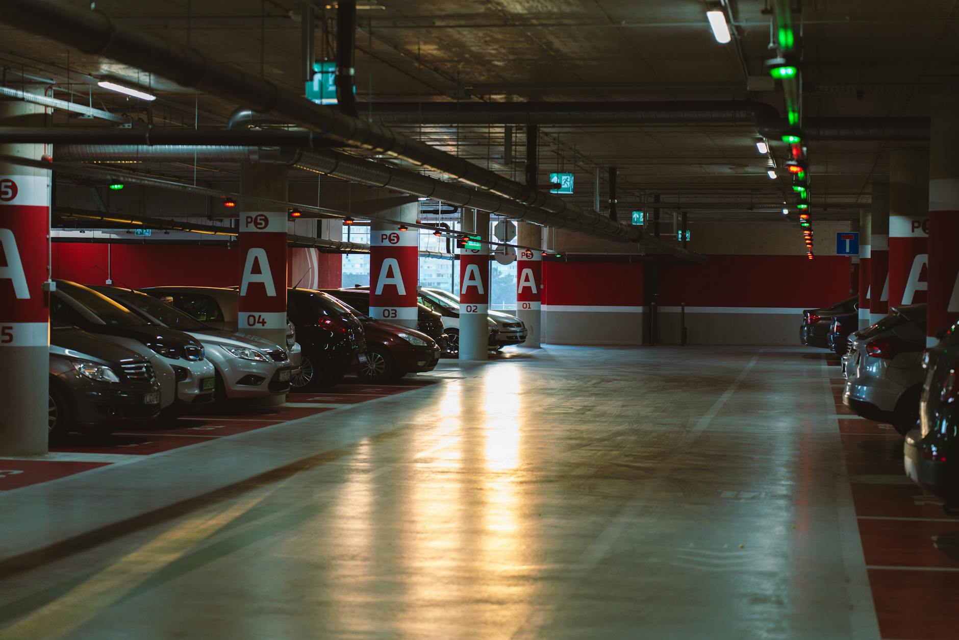 A well-lit underground parking garage with rows of spaces