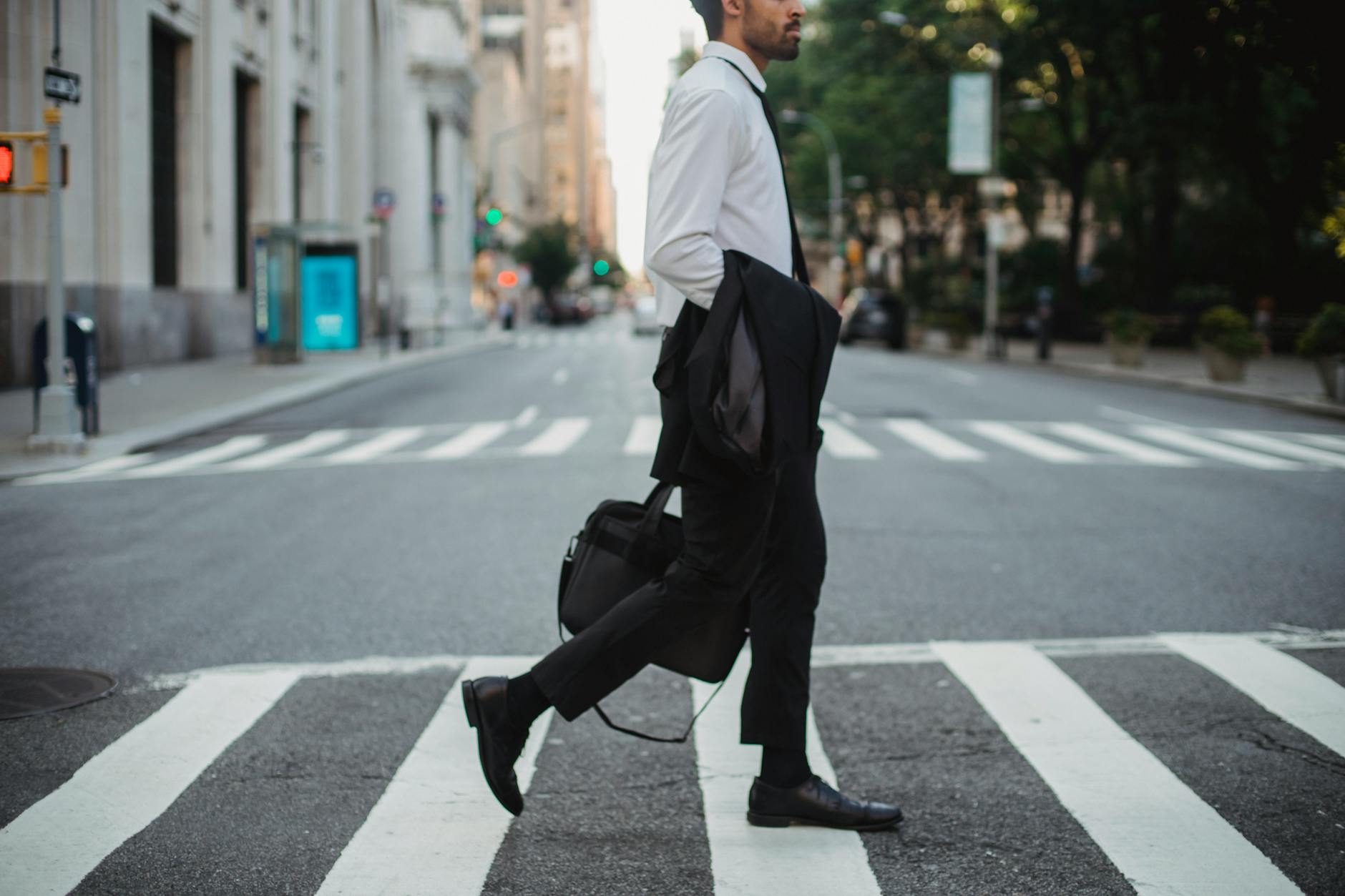 A professional walking through the city in the morning