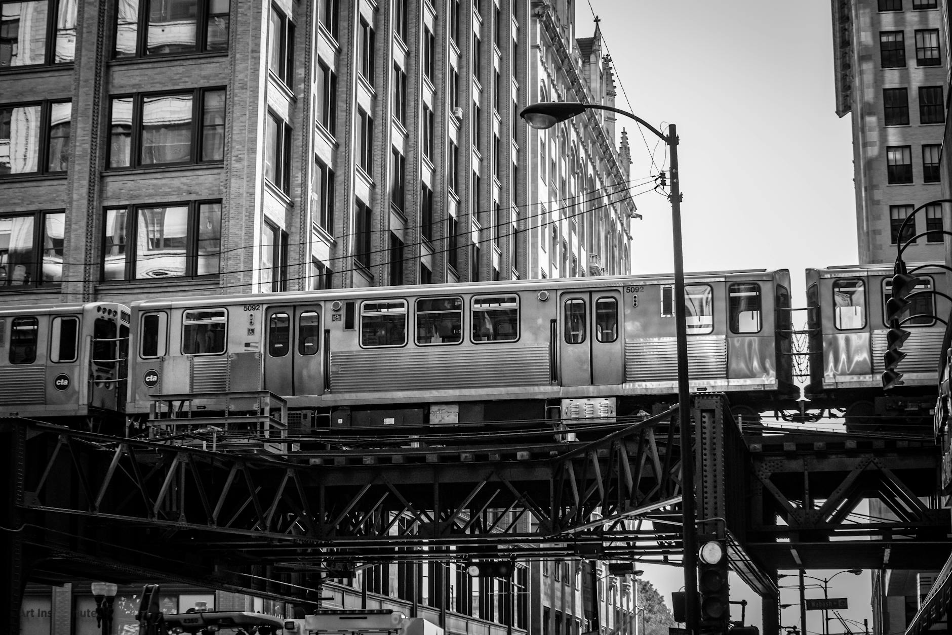 A Chicago L train traveling past historic buildings