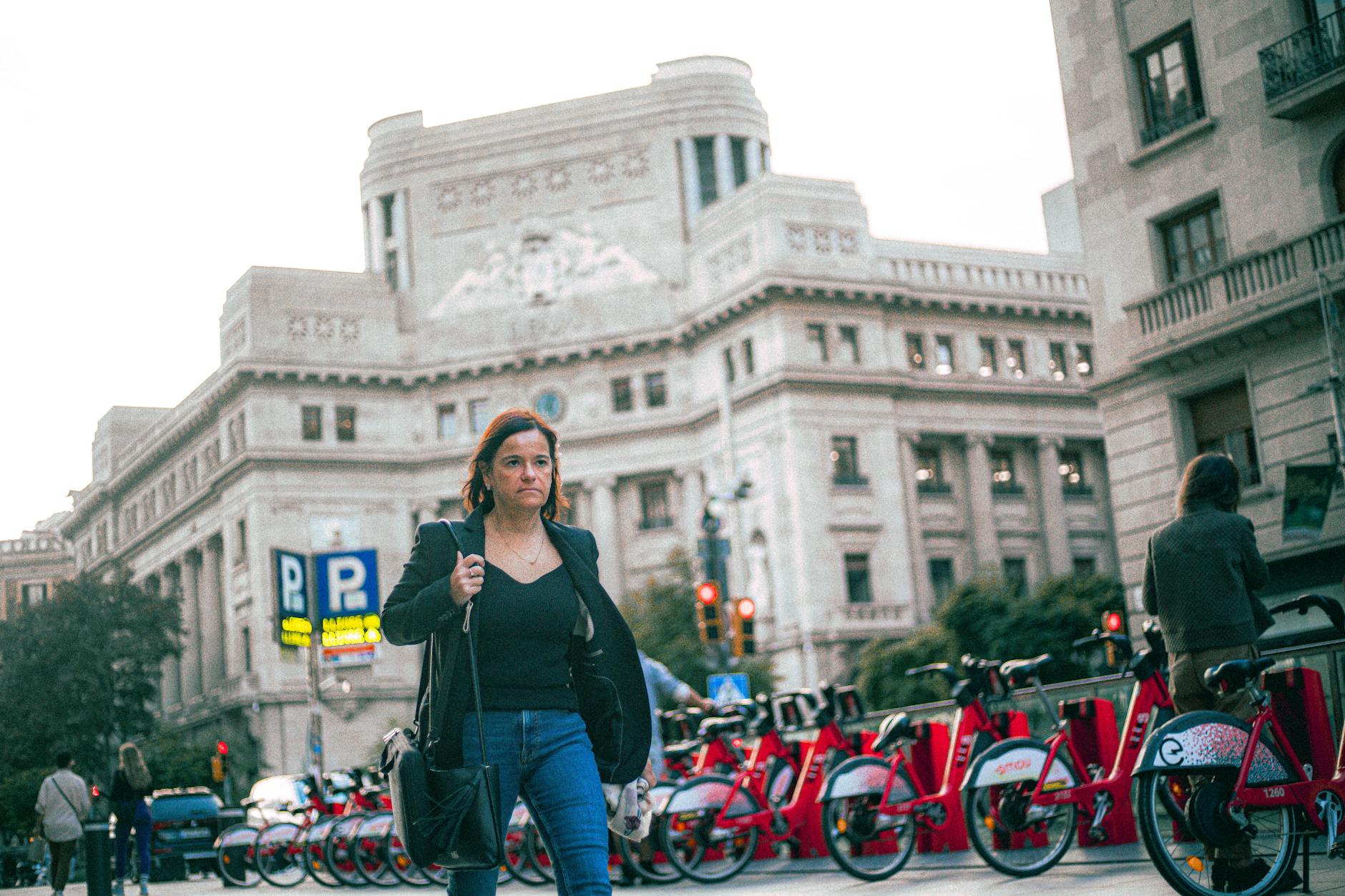 A commuter walking past a city bike-share station