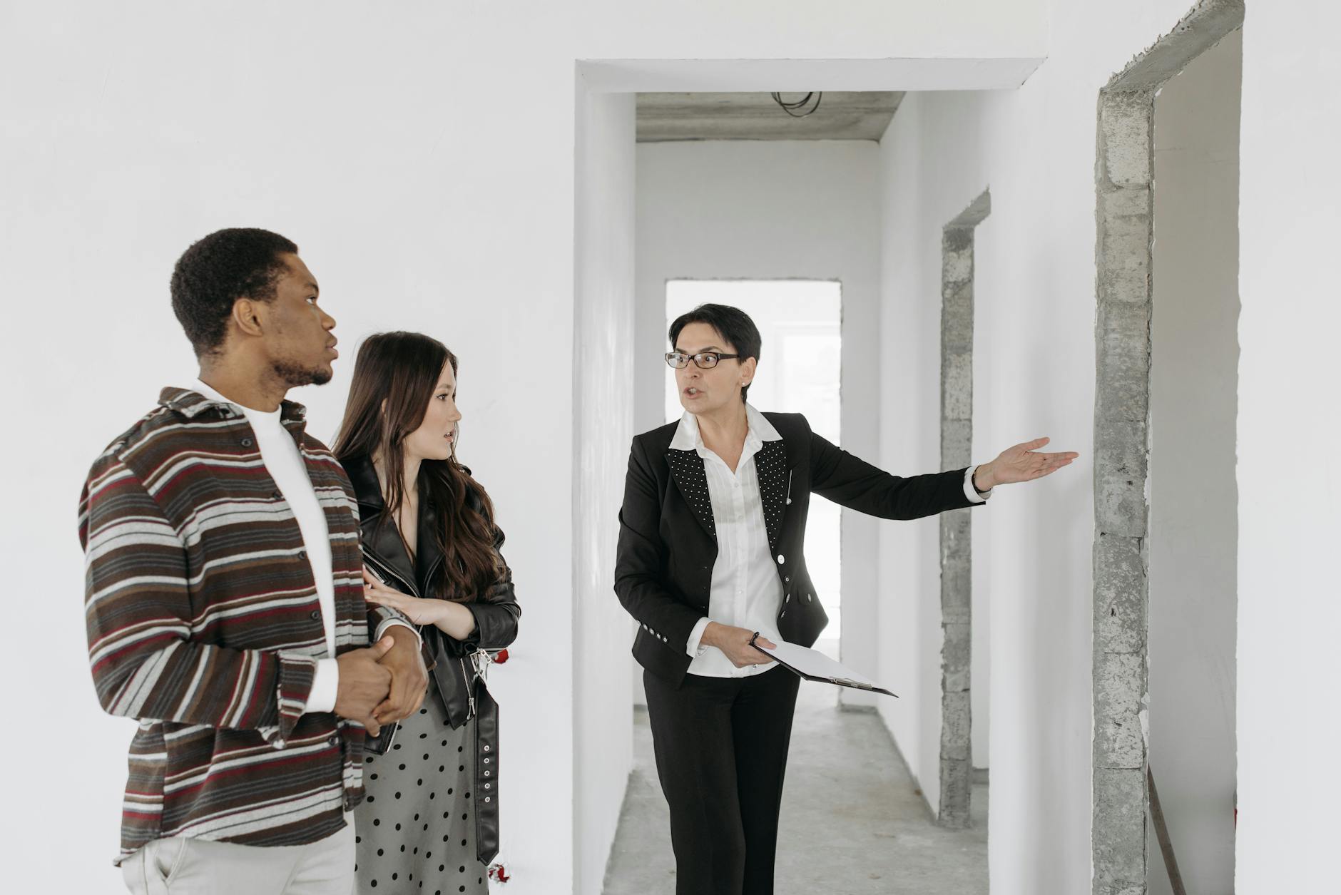 A real estate agent showing an apartment to a couple
