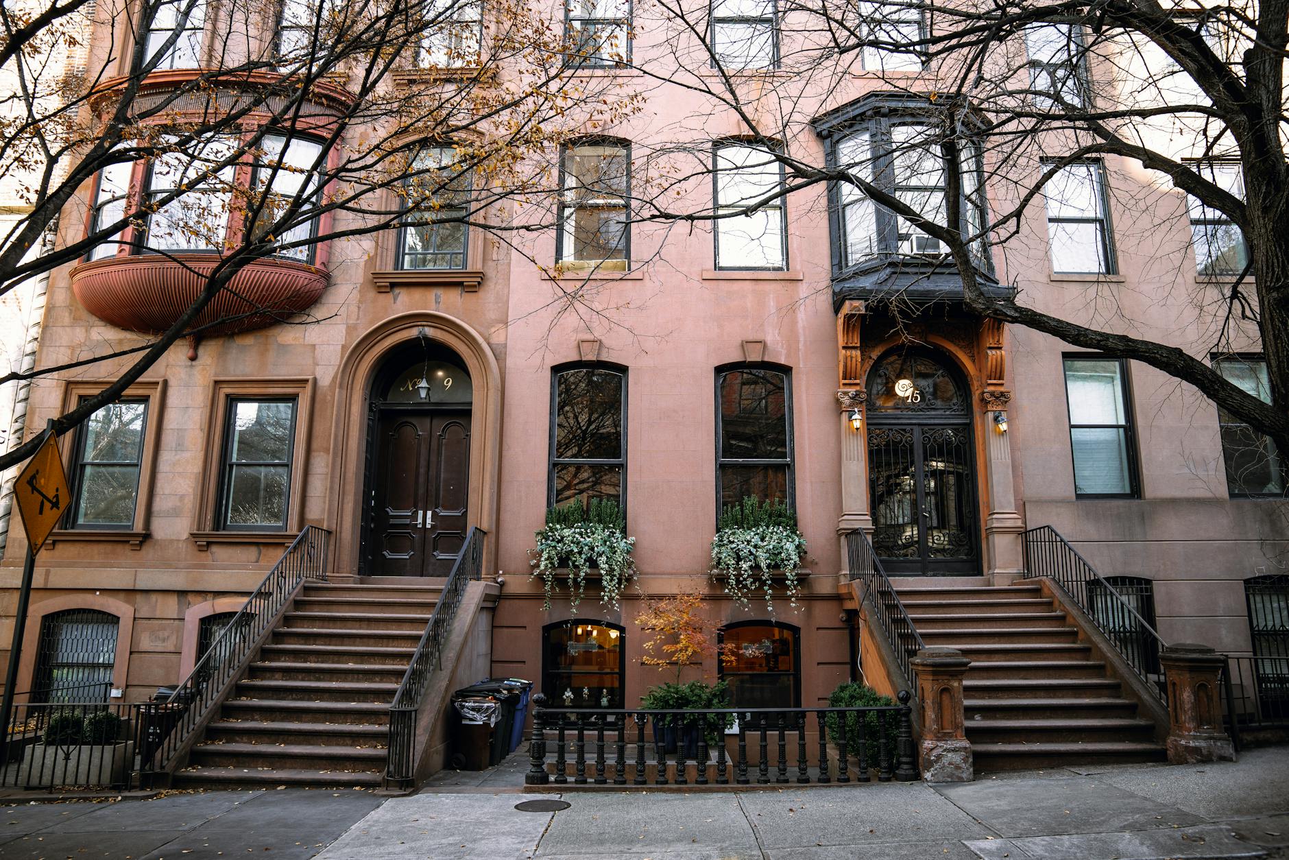 Historic brownstone row houses on a tree-lined street