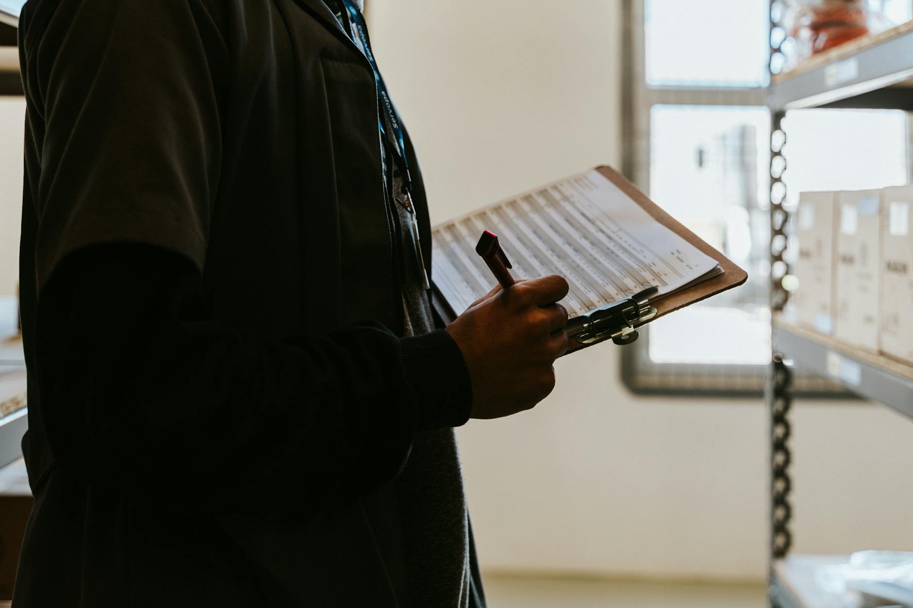 A person holding a clipboard and checklist
