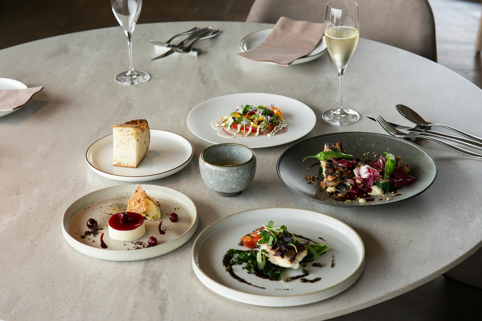 An elegant fine dining setup with gourmet dishes and wine