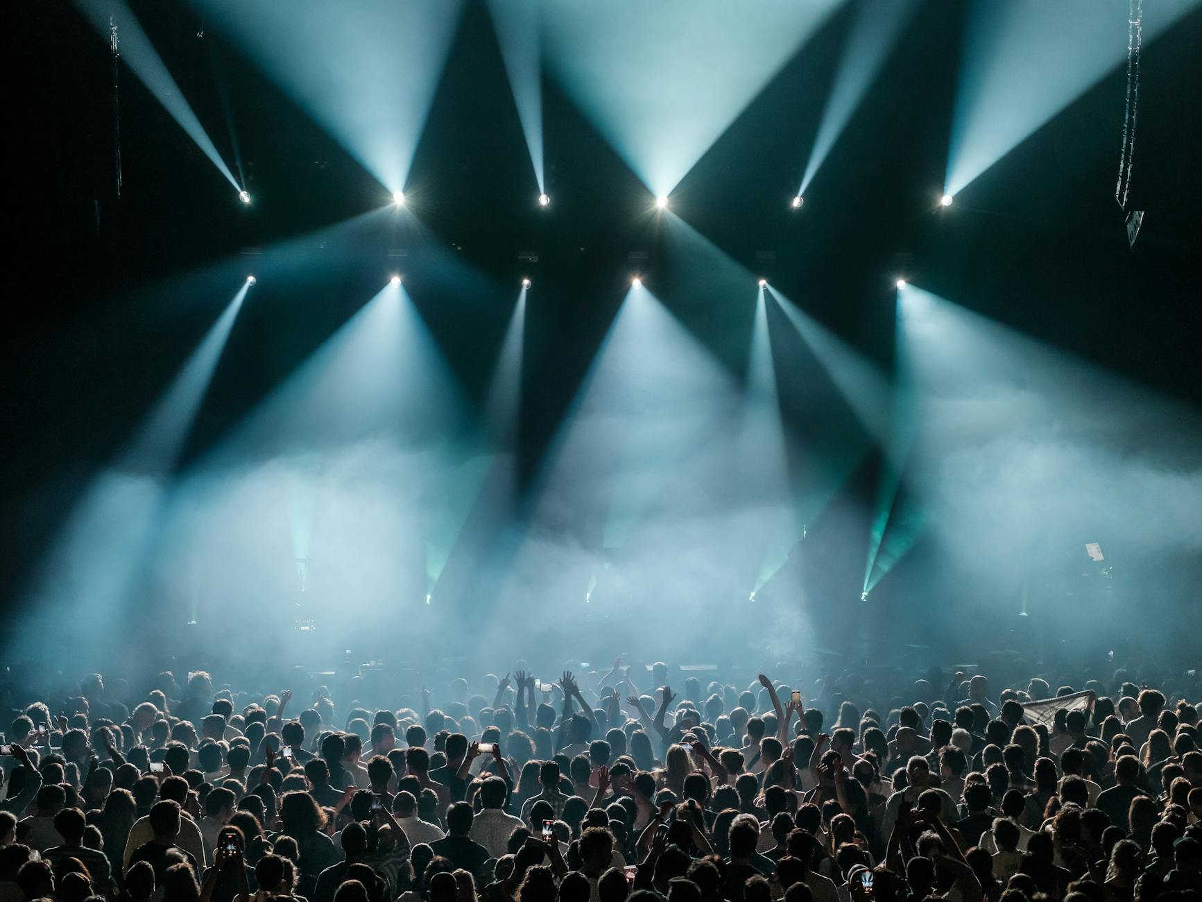 A concert crowd enjoying a live show with stage lighting