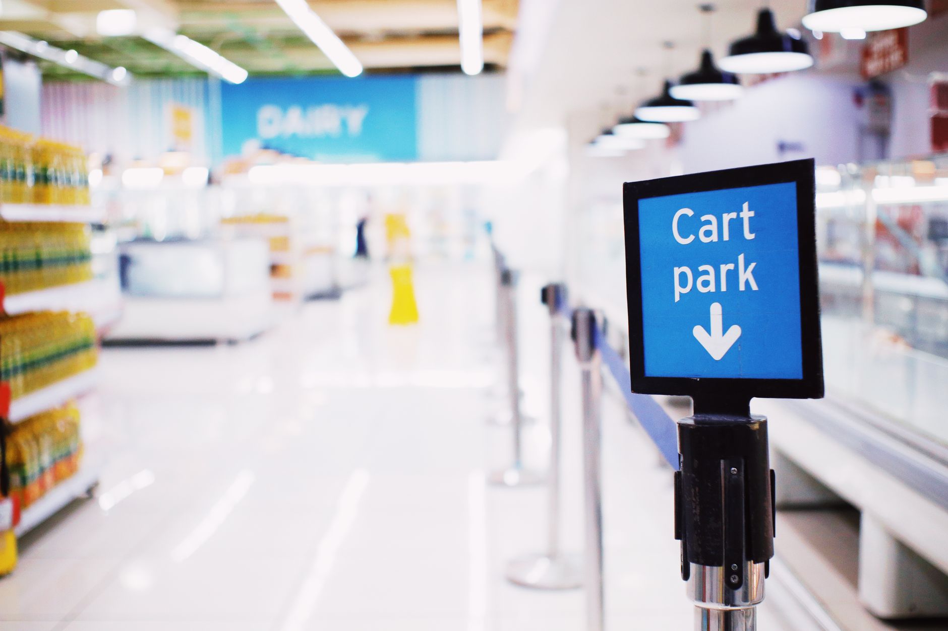 A grocery shopping cart by a store counter