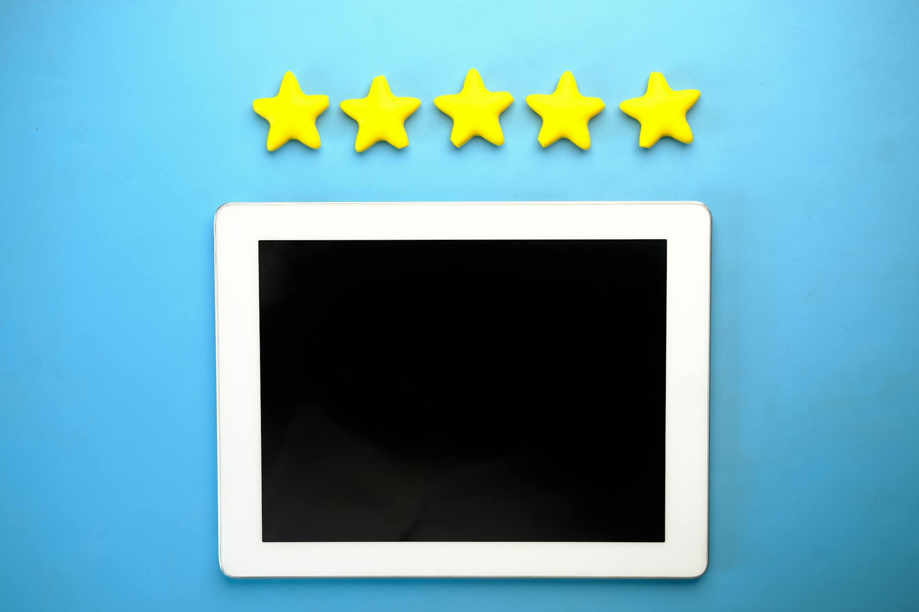 A tablet showing five yellow stars on a blue background