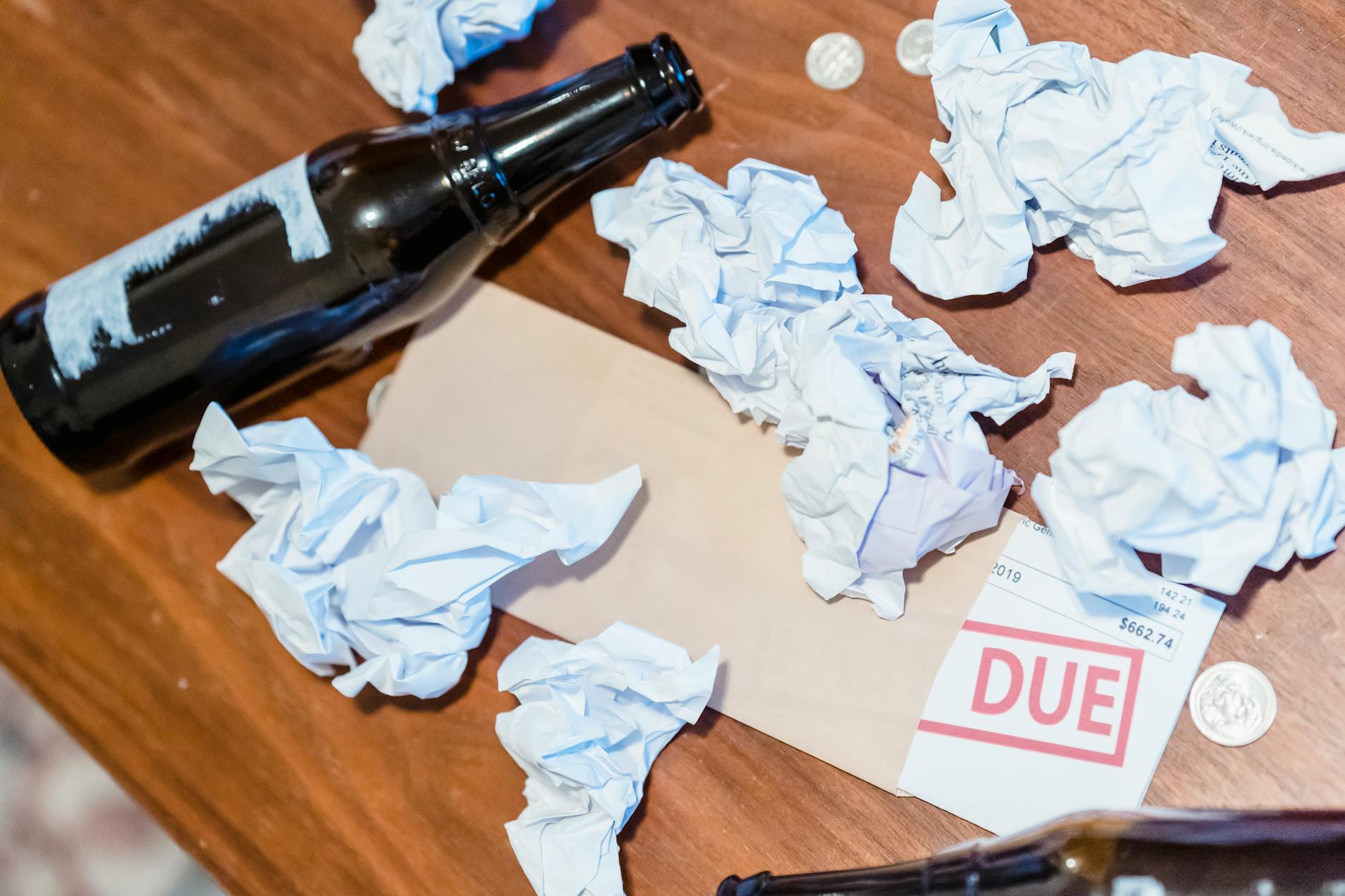 Household bills and papers on a wooden table