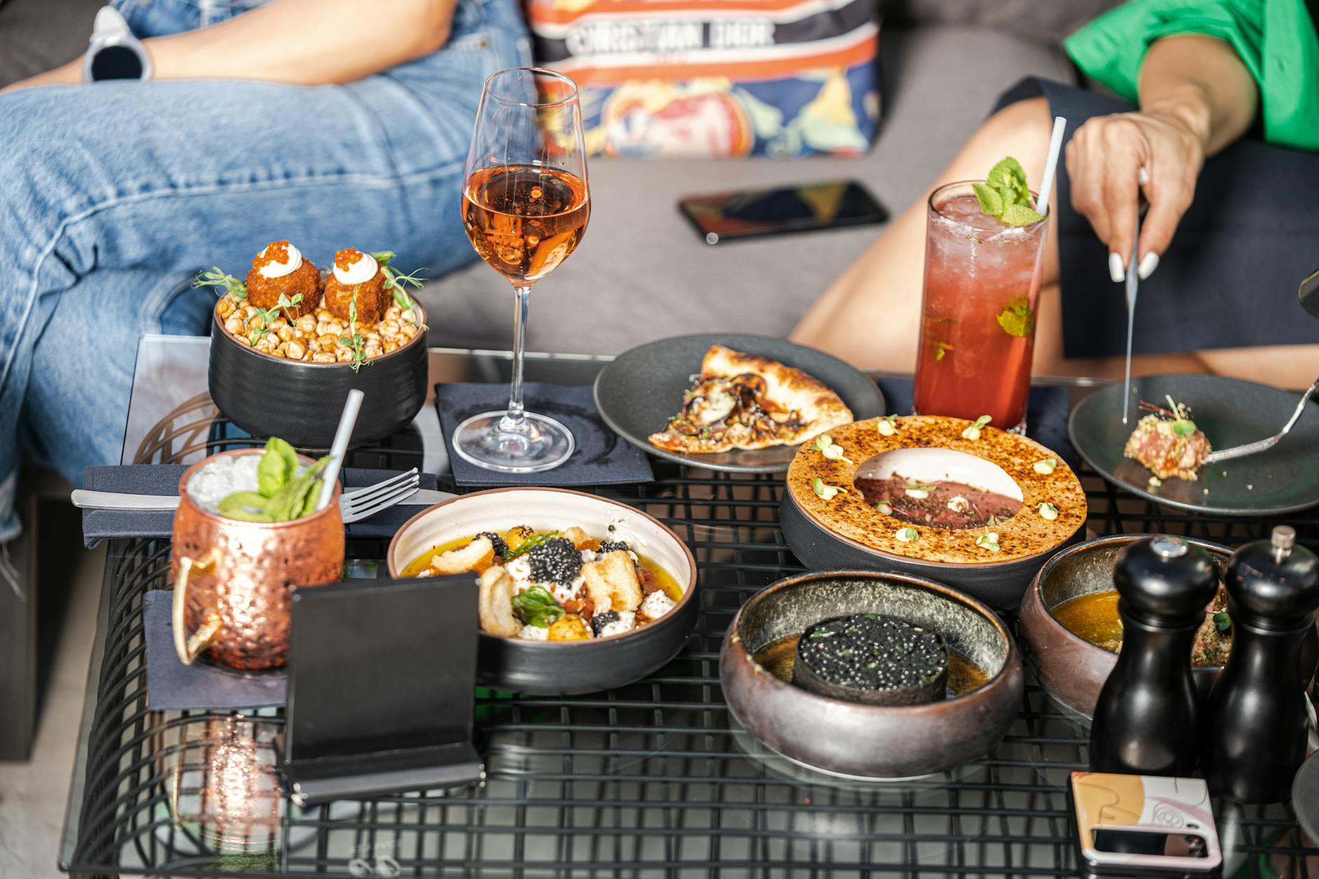 Shared plates and drinks on a casual restaurant table